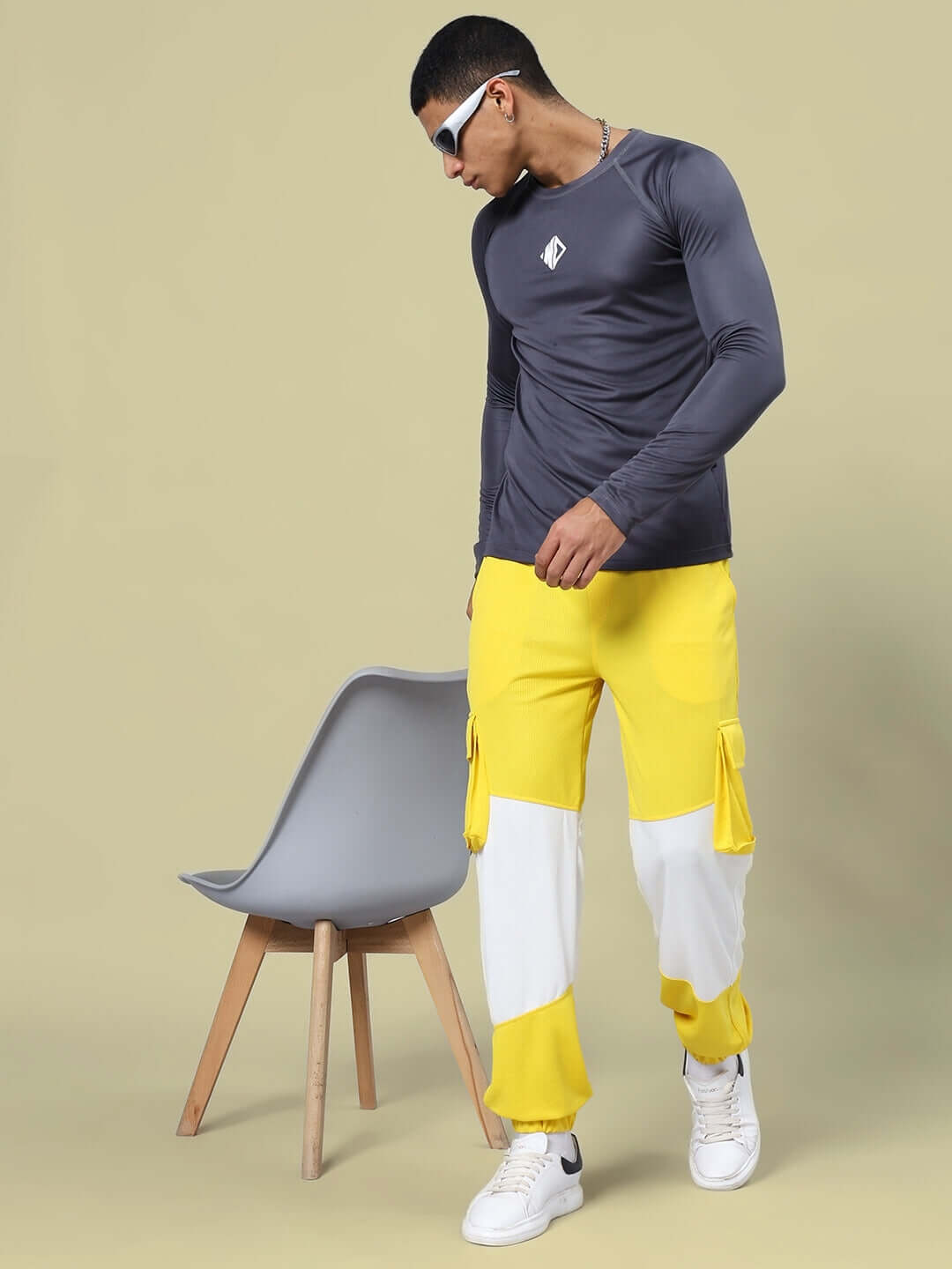 RADIANT RELAXED FIT JOGGERS YELLOW WHITE styled with dark top and white sneakers, showcasing casual fashion