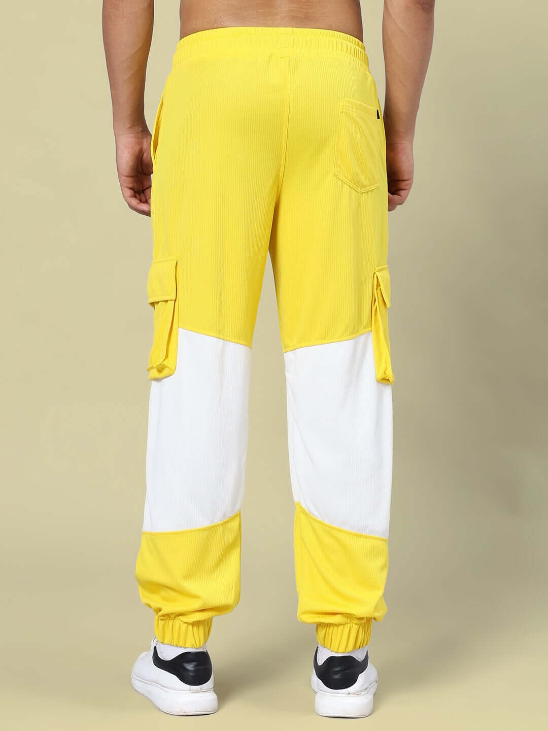 Back view of RADIANT RELAXED FIT JOGGERS YELLOW WHITE showcasing pockets and elastic cuffs.