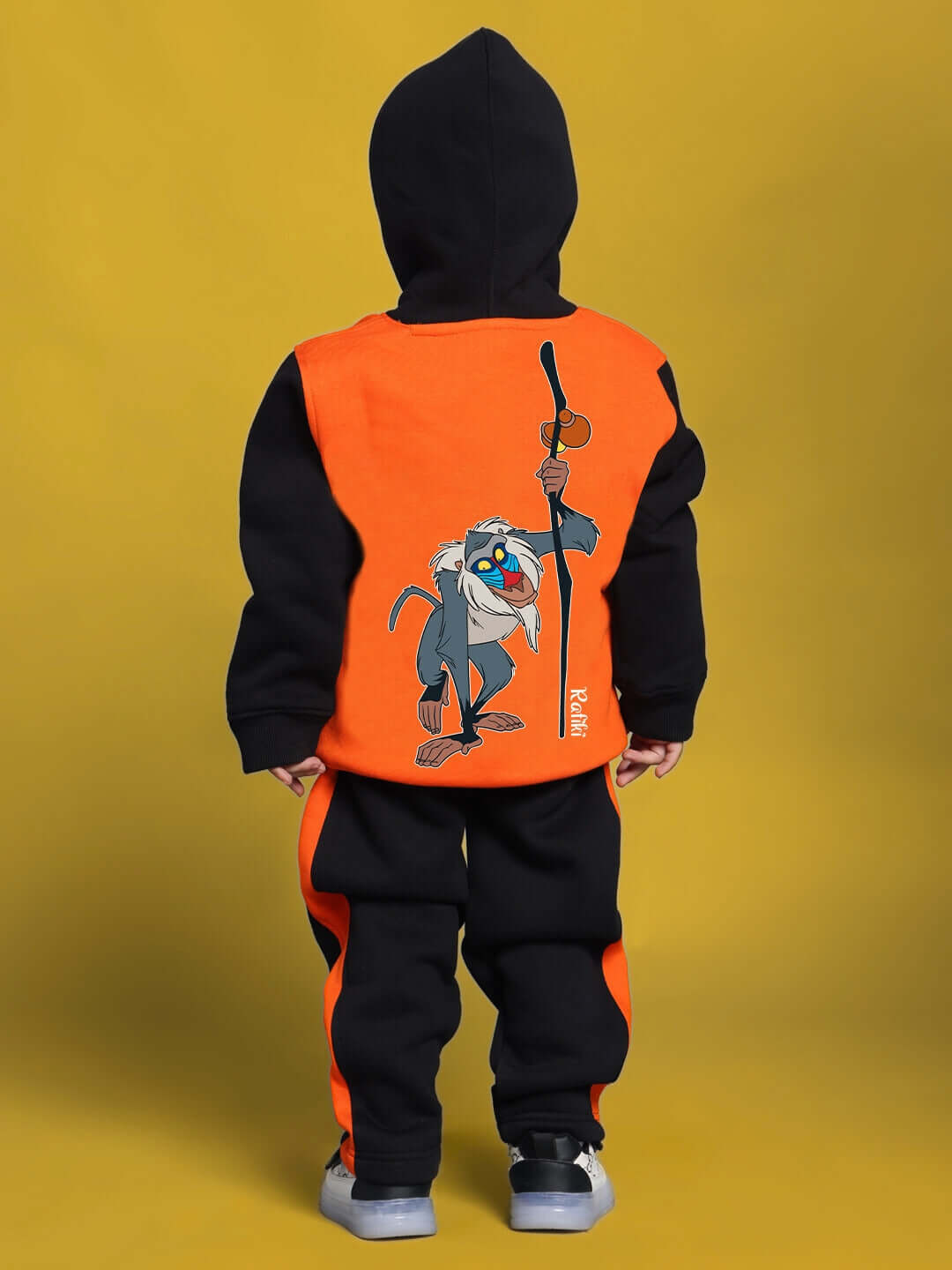 Child wearing orange-black Rafiki hoodie for boys and girls, made to order by DUDS. Offers custom fit option for personalized size.