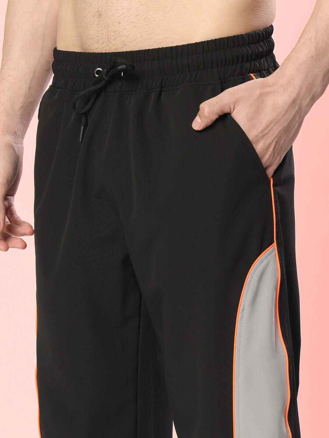 Model wearing RAGE Relaxed Fit Black-Grey Cargo Pants with custom fit option, featuring a drawstring waist and side pockets.