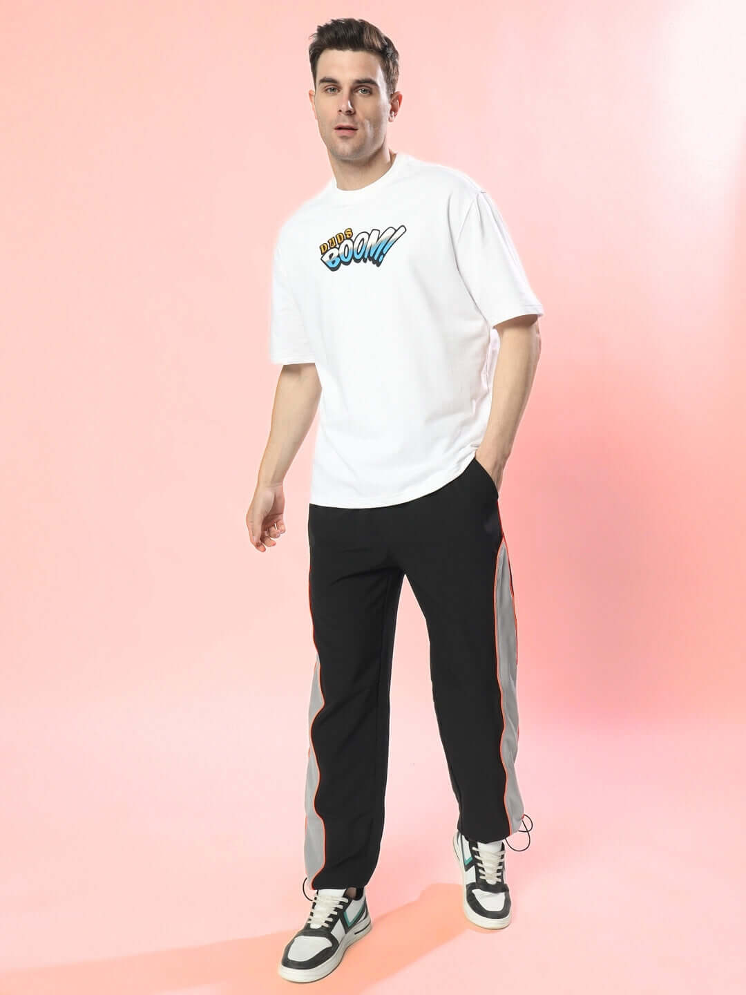 Man wearing Rage Relaxed Fit Cargo Pants in black-grey with custom fit option.