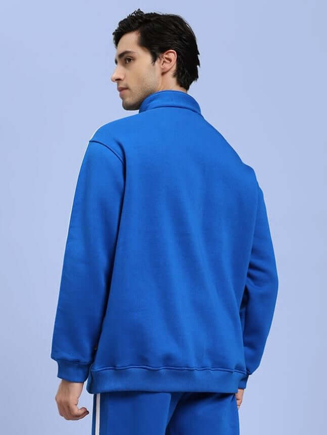 Man wearing Rapid Stride cotton fleece jacket royal blue, showcasing the back design, perfect for active outdoor activities.