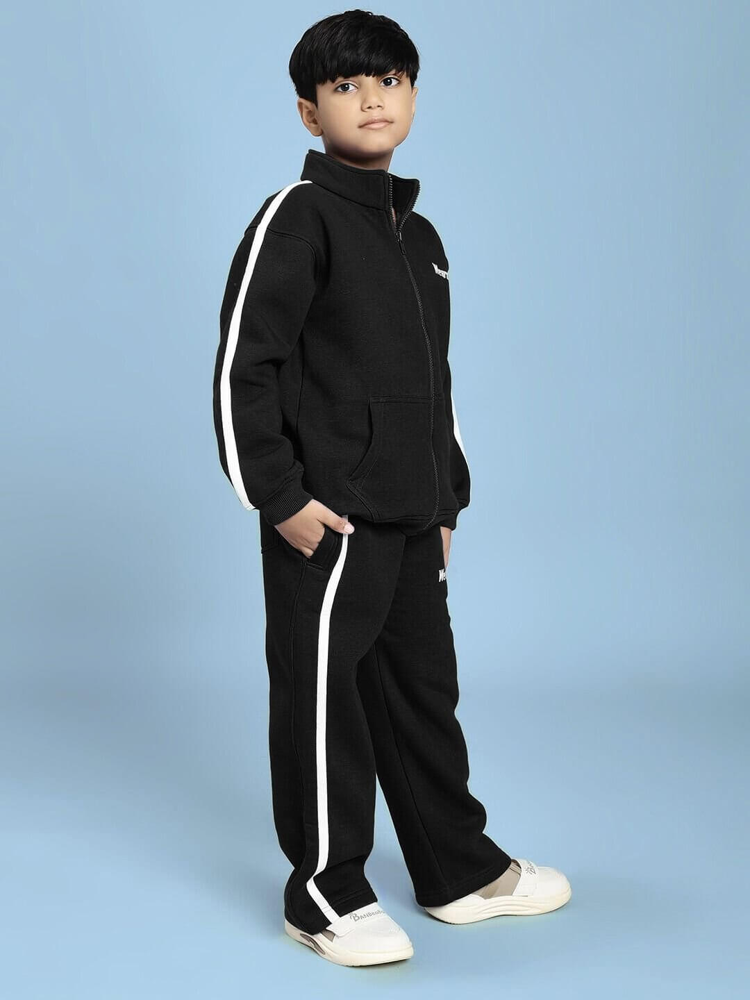 Child wearing RAPID STRIDE FLEECE CO-ORD FOR BOYS AND GIRLS BLACK with sporty design on a blue background.