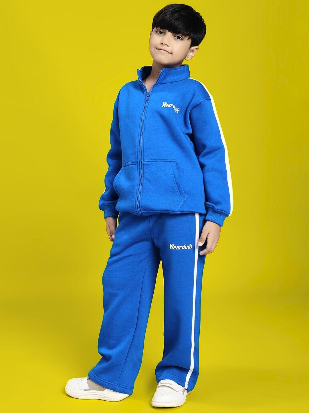 Boy wearing RAPID STRIDE FLEECE CO-ORD FOR BOYS AND GIRLS ROYAL BLUE, standing confidently against a vibrant yellow background.