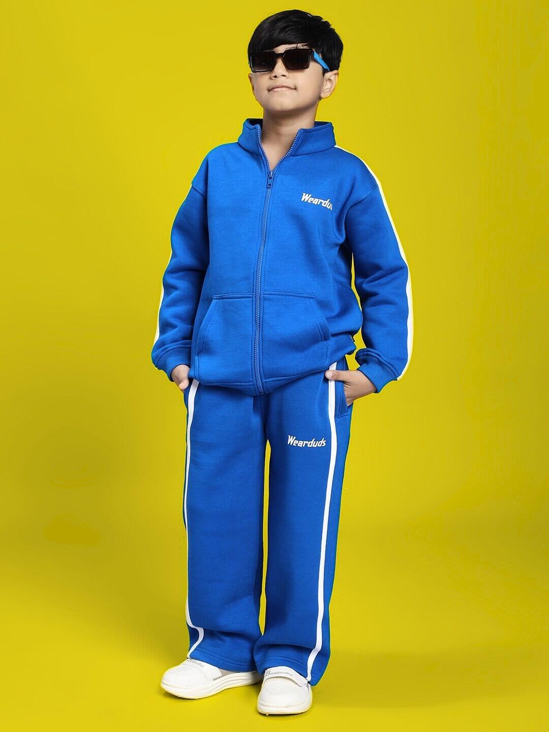 Child in RAPID STRIDE FLEECE CO-ORD FOR BOYS AND GIRLS ROYAL BLUE outfit, featuring a matching royal blue jacket and joggers, posing confidently.