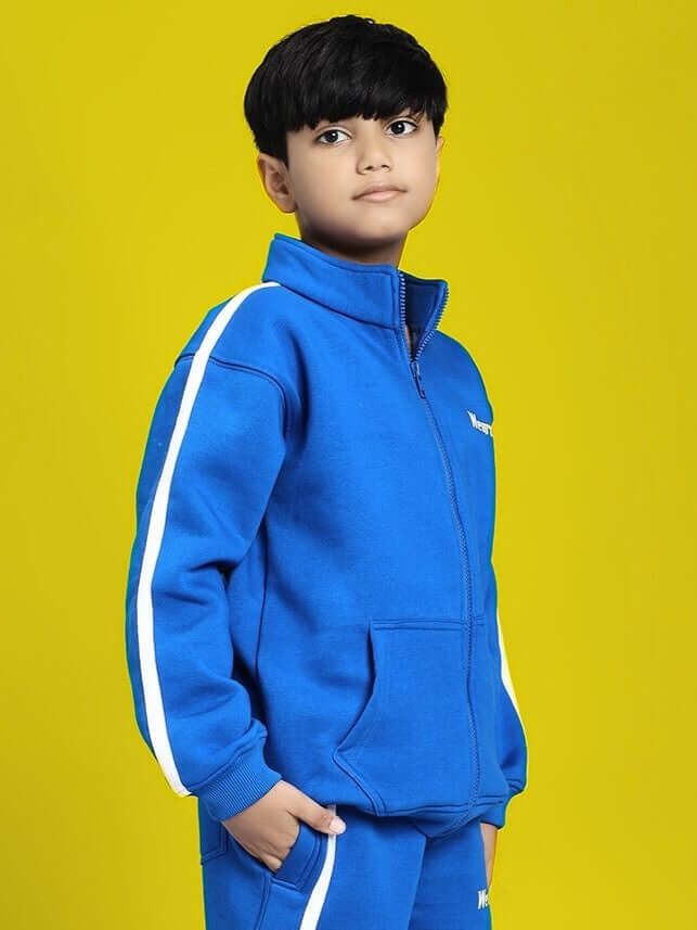 Child wearing Rapid Stride Fleece Jacket for Boys and Girls Royal Blue, showcasing sporty and comfortable design on a yellow background.