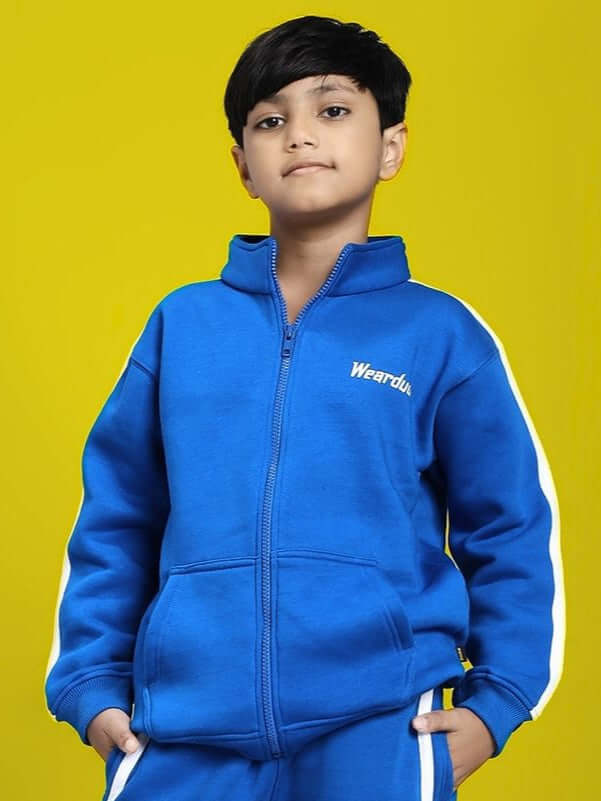Boy wearing RAPID STRIDE FLEECE JACKET FOR BOYS AND GIRLS ROYAL BLUE standing confidently against a yellow background.