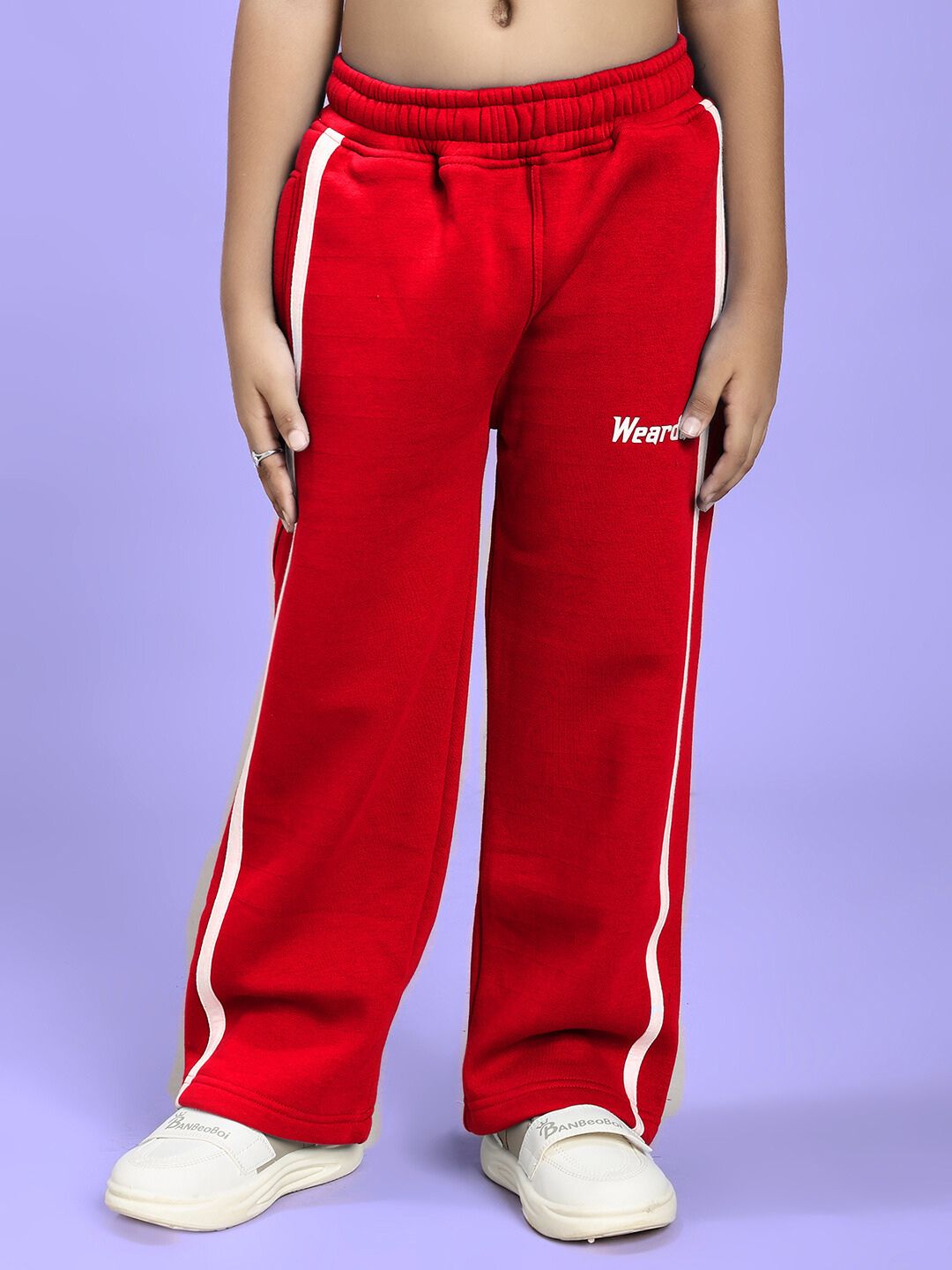 Child wearing RAPID STRIDE FLEECE JOGGER FOR BOYS AND GIRLS RED, showcasing comfort and style with white stripe accents.