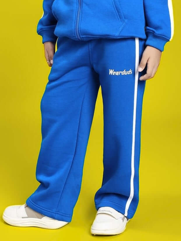 Child wearing RAPID STRIDE FLEECE JOGGER FOR BOYS AND GIRLS ROYAL BLUE showcasing comfortable and stylish kidswear.