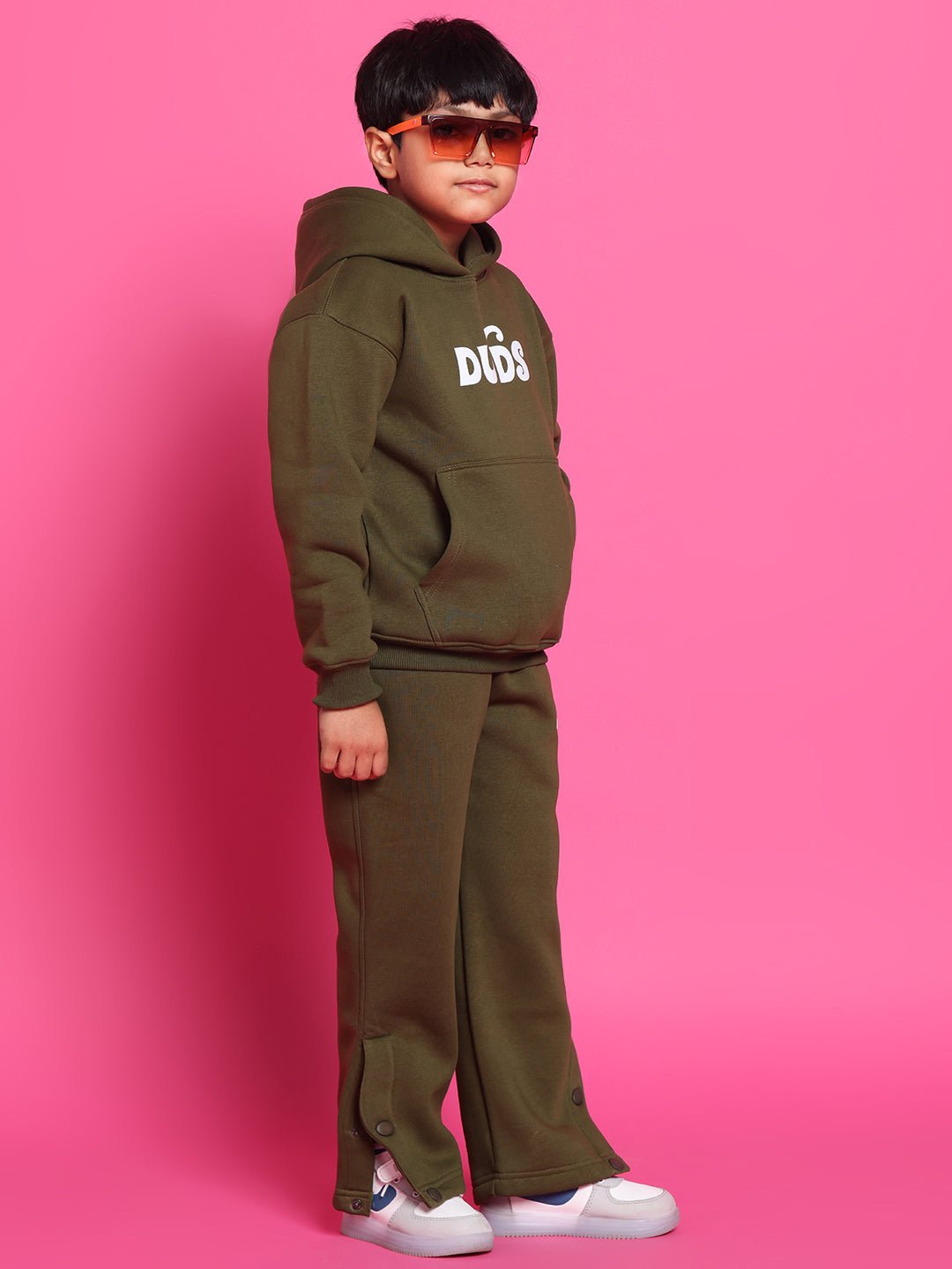 Child wearing RARE EDITION CO-ORD FOR BOYS GIRLS OLIVE GREEN against pink background, showcasing trendy casual kids' fashion.