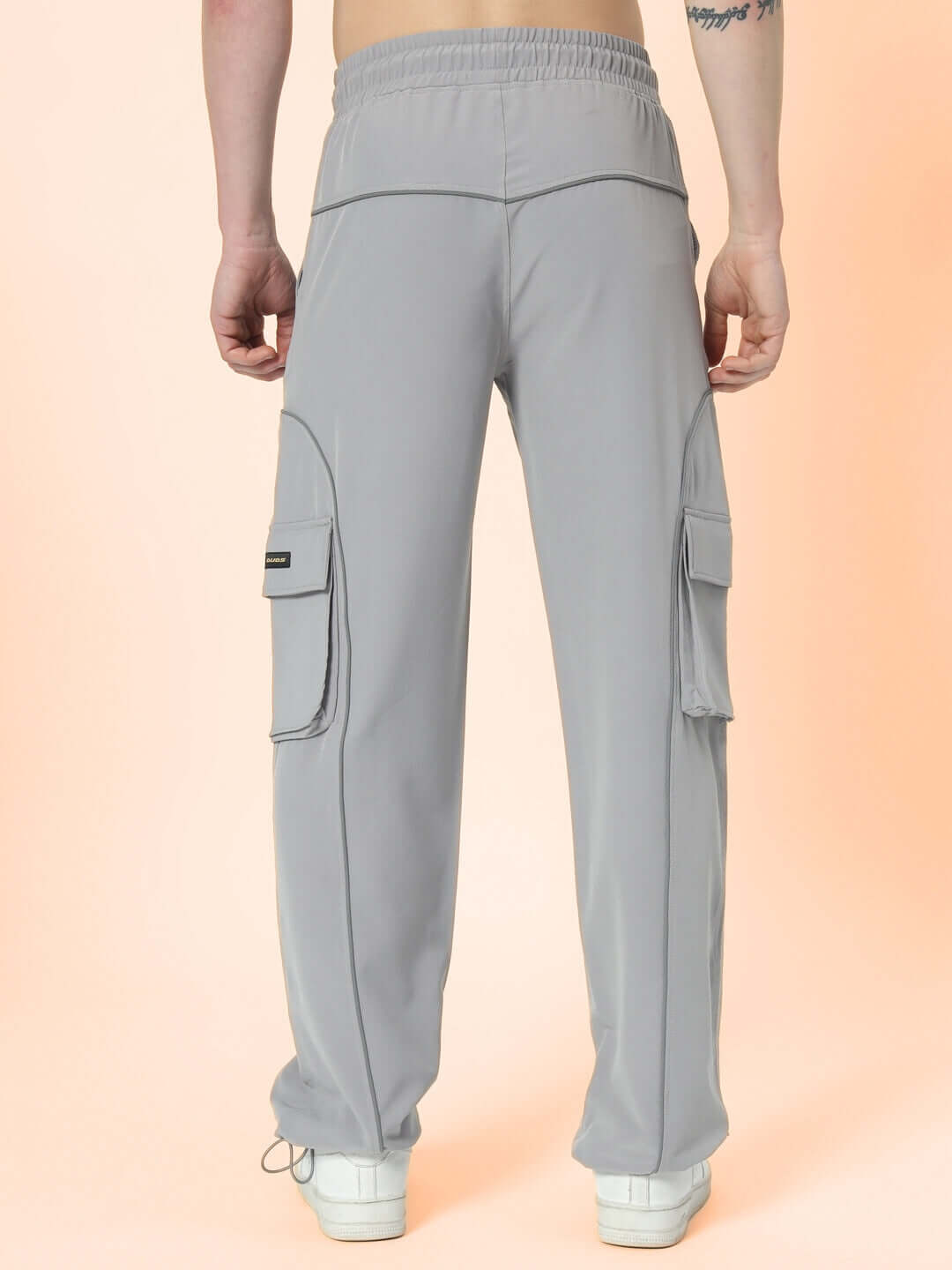 Back view of grey Ray Reflector Parachute Cargo Pants showcasing comfort fit and side pockets.