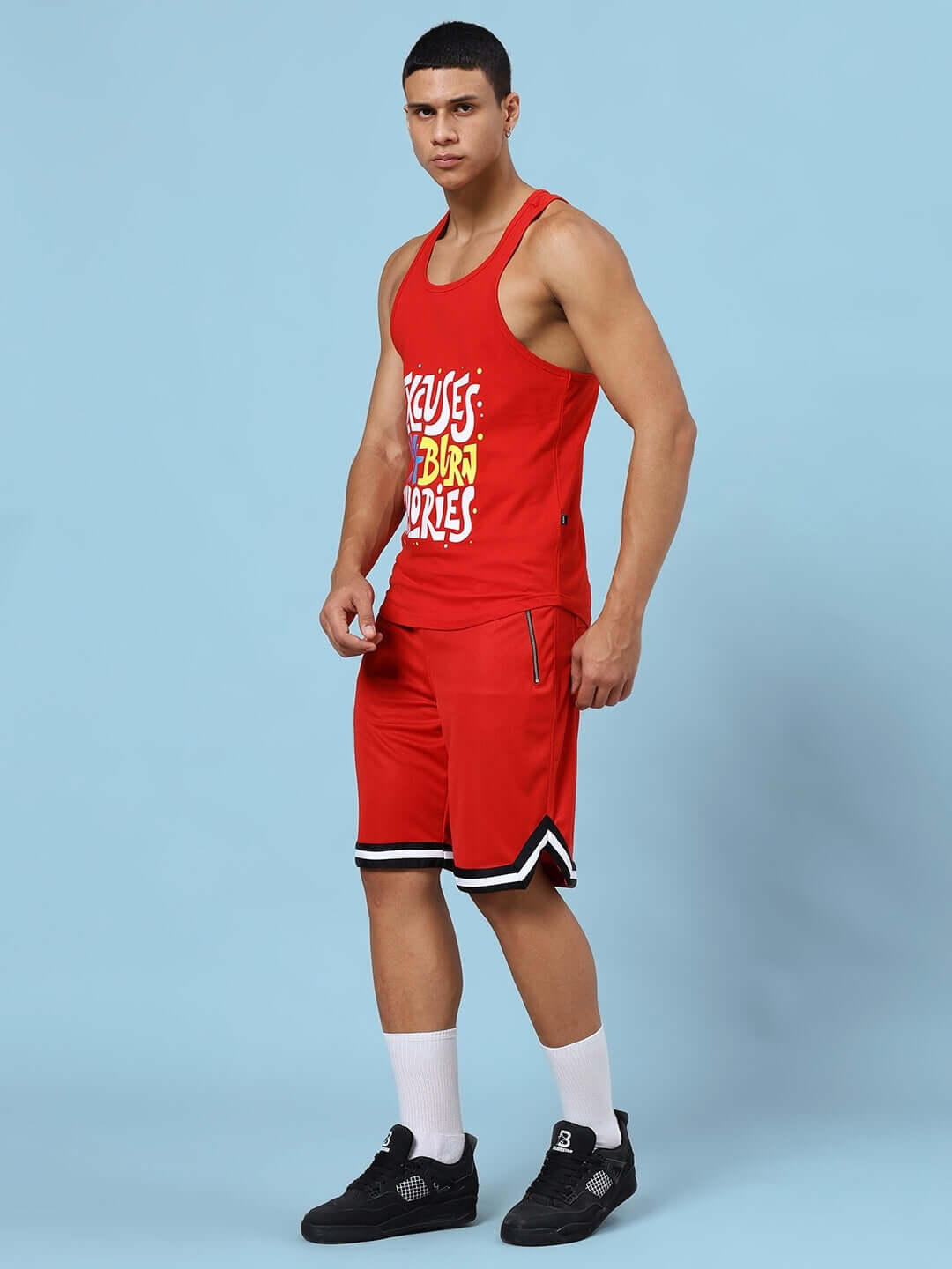 Man wearing EXCUSES DON'T BURN CALORIES PRINTED GYM CO-ORD SET RED, including a tank top and shorts, ideal for fitness enthusiasts.