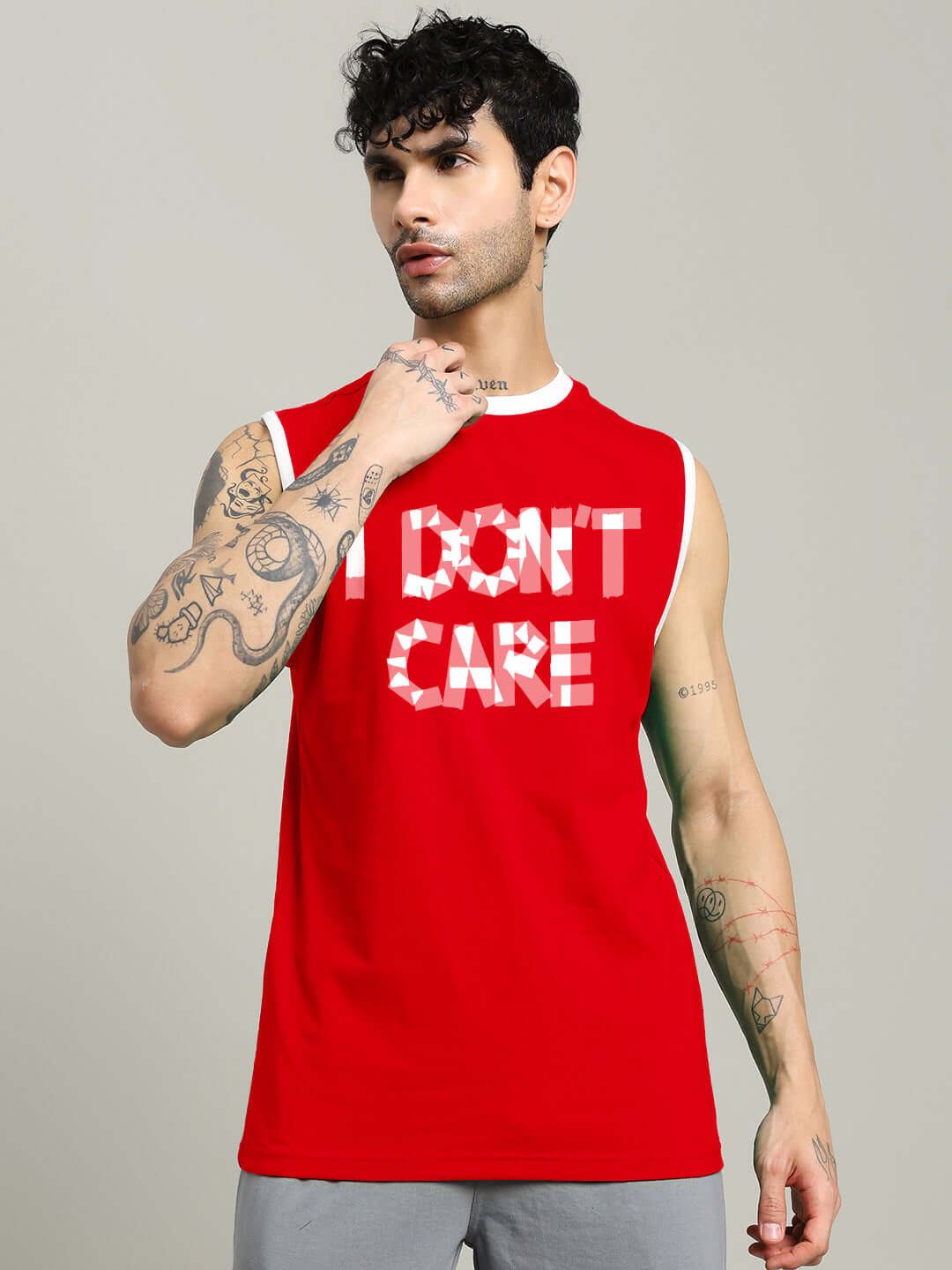 Man wearing red 'I DON'T CARE' gym t-shirt, customizable size option available, handmade with dedication for perfect fit.