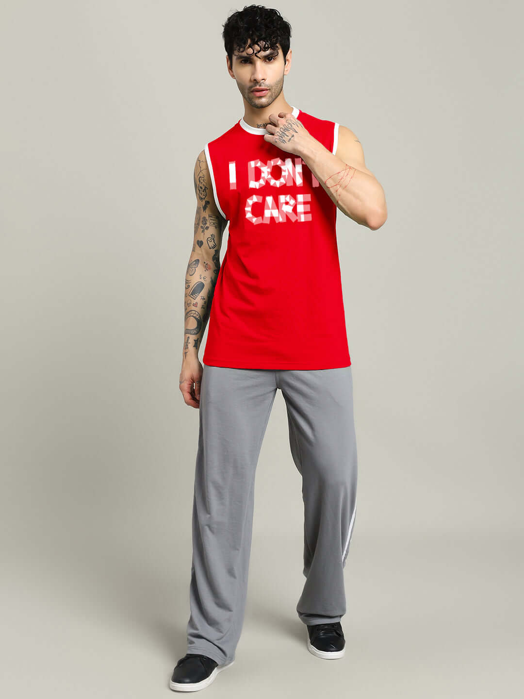 Model wearing red 'I DON'T CARE' gym t-shirt with customizable size option, front view, promoting casual activewear style.