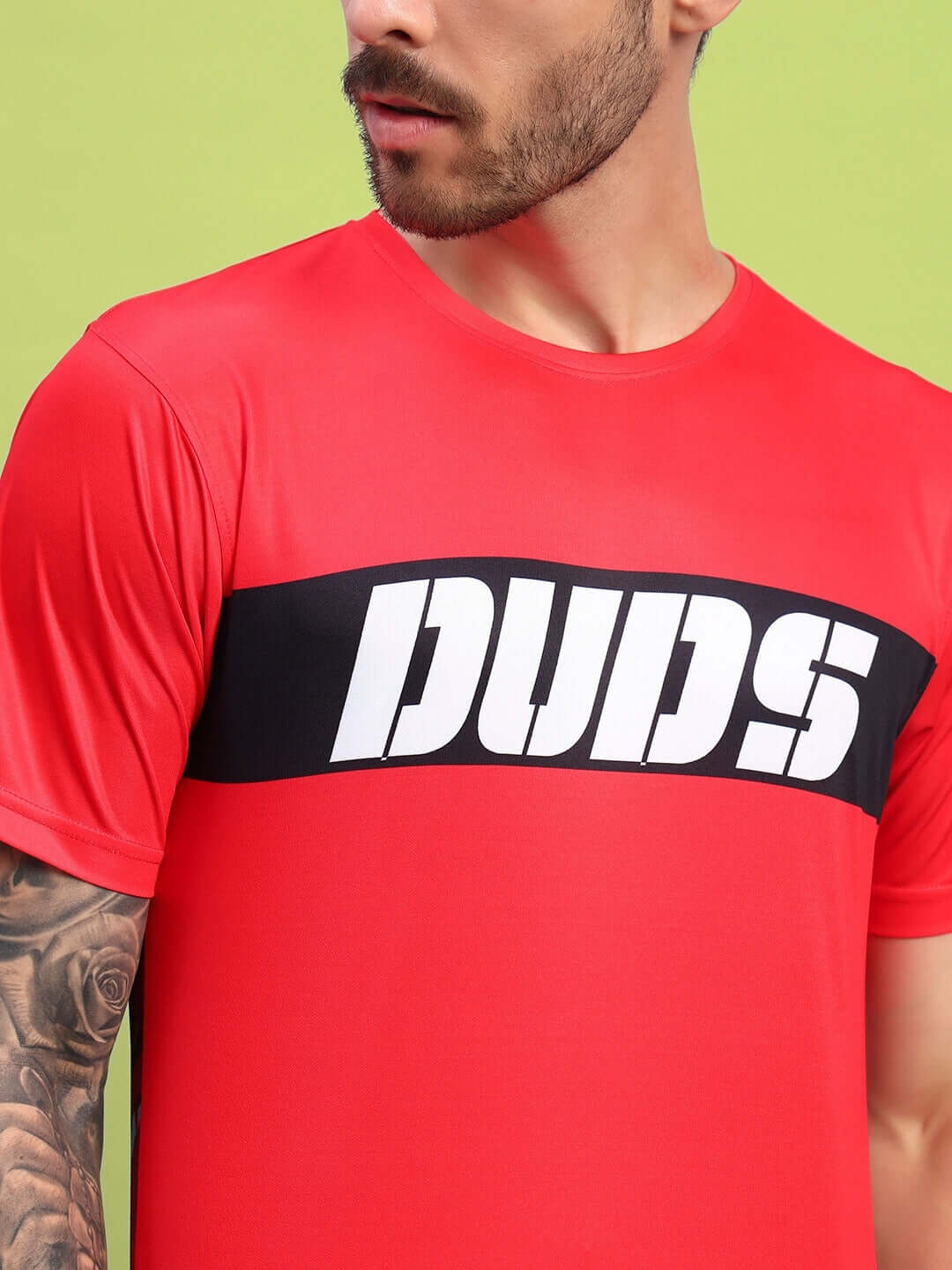 Red stylized leopard printed t-shirt with bold 'DUDS' text, crafted from sports polyester fabric, perfect for casual and sporty looks.