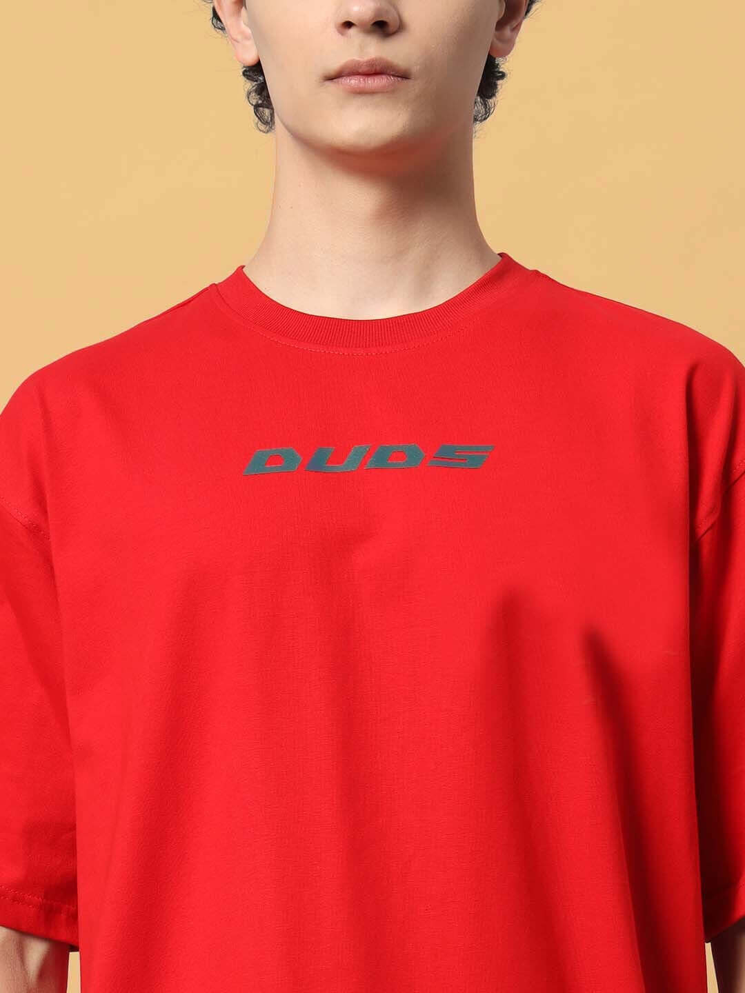 Red oversized t-shirt with 'DUDS' logo, customizable size option available, handmade and dispatched in 7-10 days.