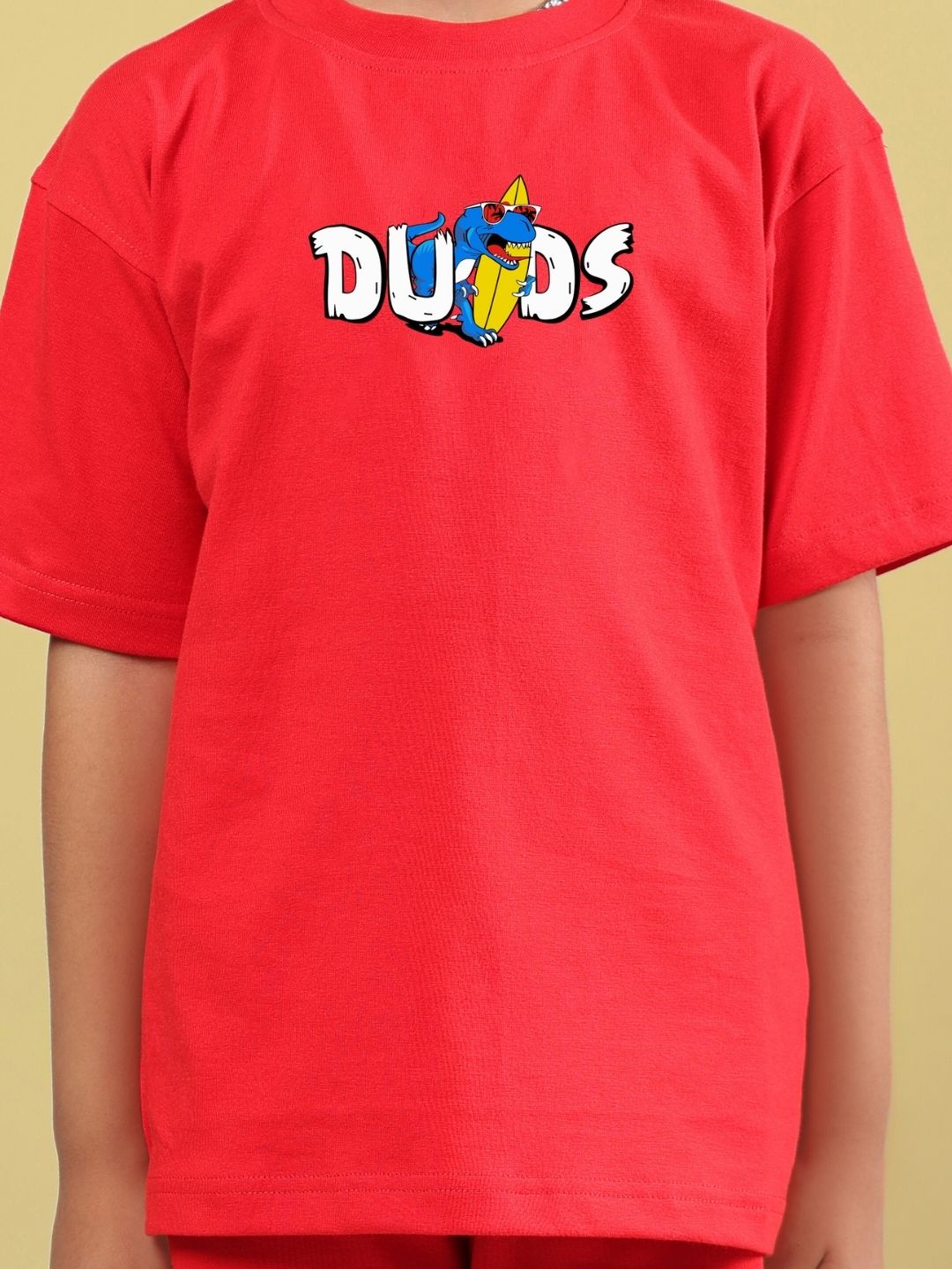 Child wearing CATCH THE WAVES CO-ORD FOR BOYS & GIRLS RED set featuring a vibrant red t-shirt with playful graphics.