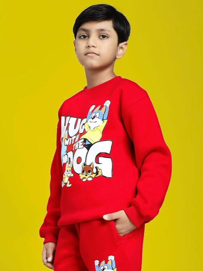 Child wearing HUG WITH THE DOG FLEECE SWEATSHIRT FOR BOYS AND GIRLS RED, featuring playful dog print, vibrant and cozy design.