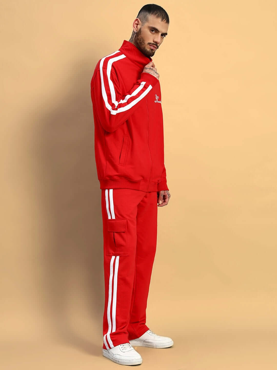 Model wearing WEARDUDS SCOTIA CO-ORD SET RED in premium heavy gauge 100% cotton terry fabric with white stripes, standing on beige background.