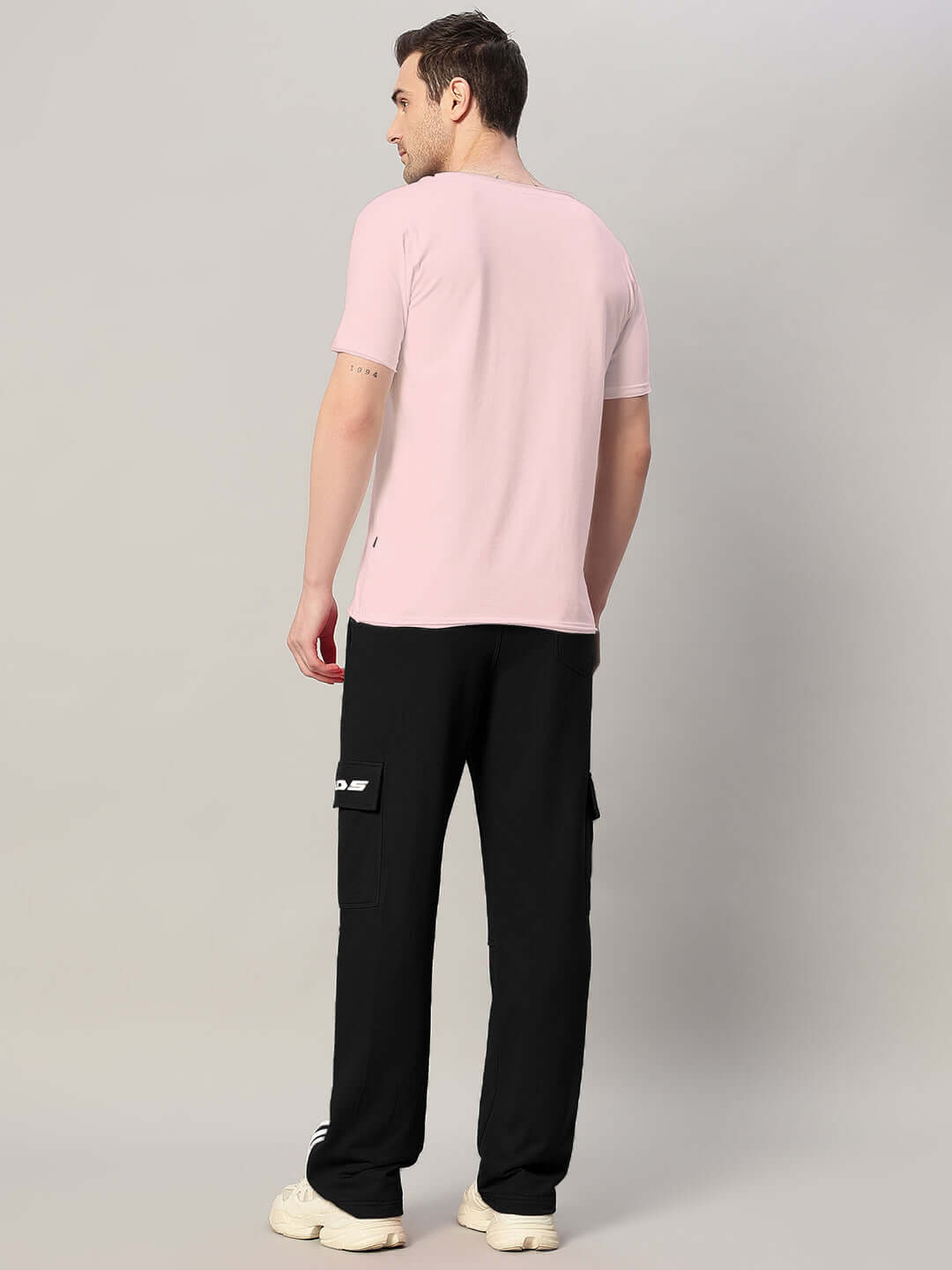 Man wearing REDROIT relaxed fit joggers in black, side view showcasing comfortable fit, from DUDS.