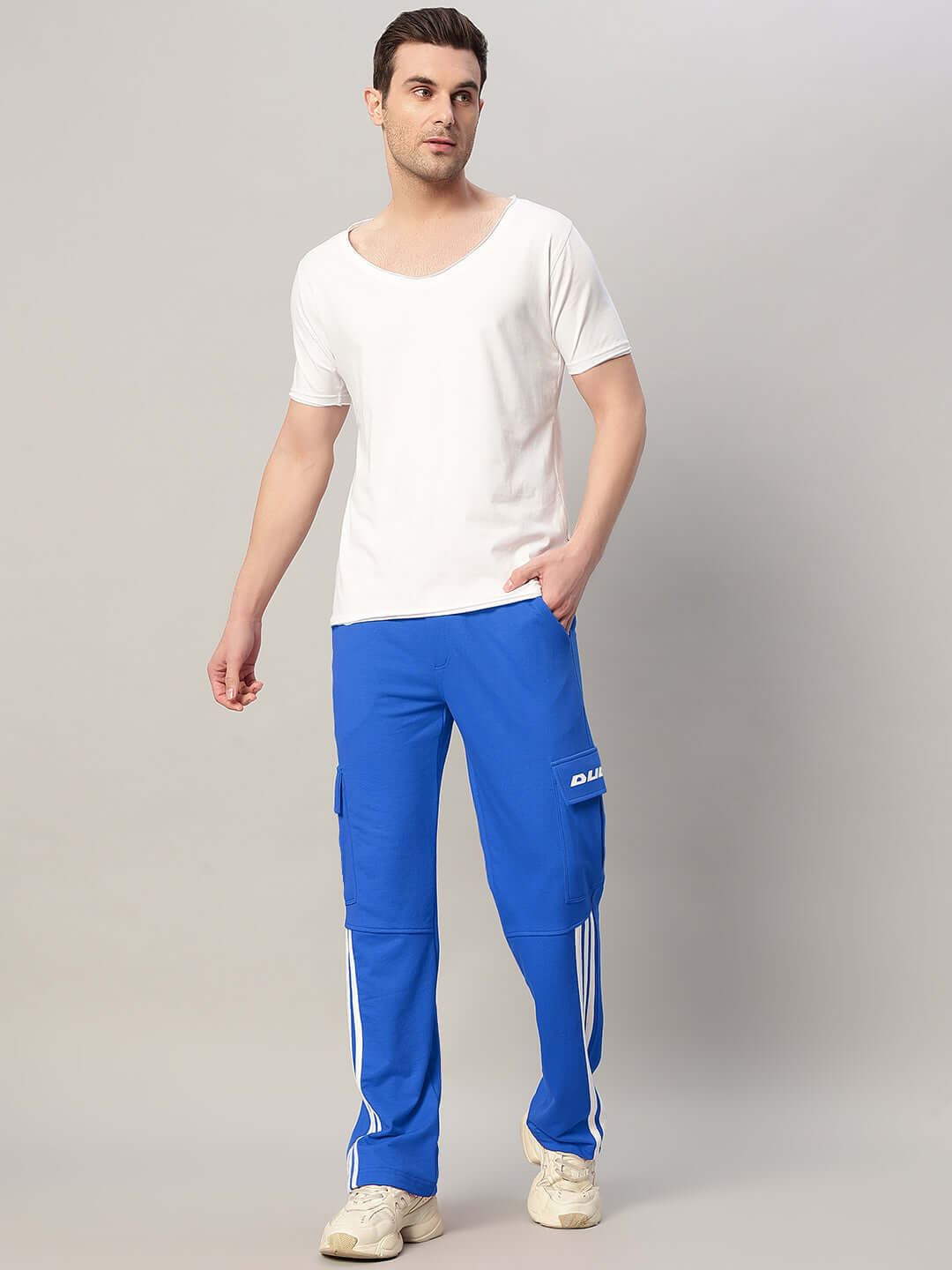 Man wearing REDROIT relaxed fit blue joggers by DUDS, featuring 5 pockets, perfect for casual wear and custom size options.