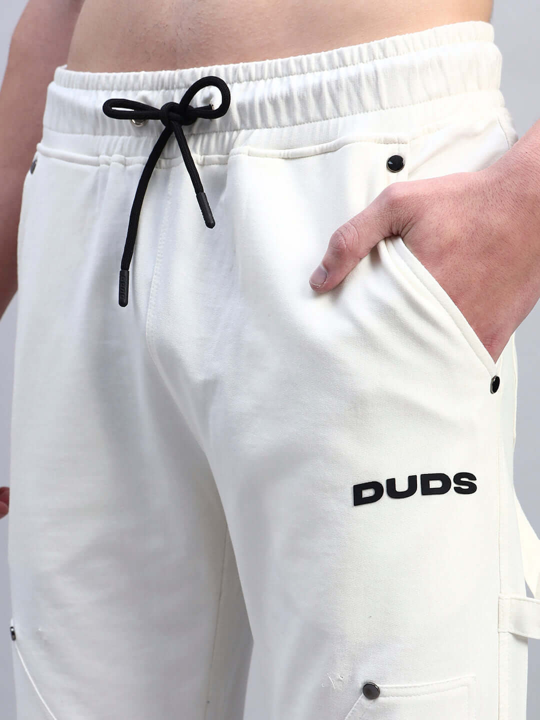 Man wearing REGULUS RELAXED-FIT JOGGERS WHITE with black drawstring and sleek modern design.