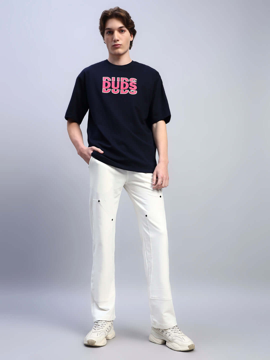 Model wearing REGULUS RELAXED-FIT JOGGERS WHITE, featuring comfortable cotton-blend fabric for modern streetwear.