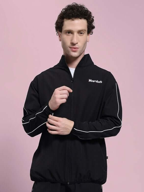 Model wearing RELIGHT RELAXED FIT JACKET BLACK with reflective trim for enhanced visibility, ideal for workouts or casual wear.