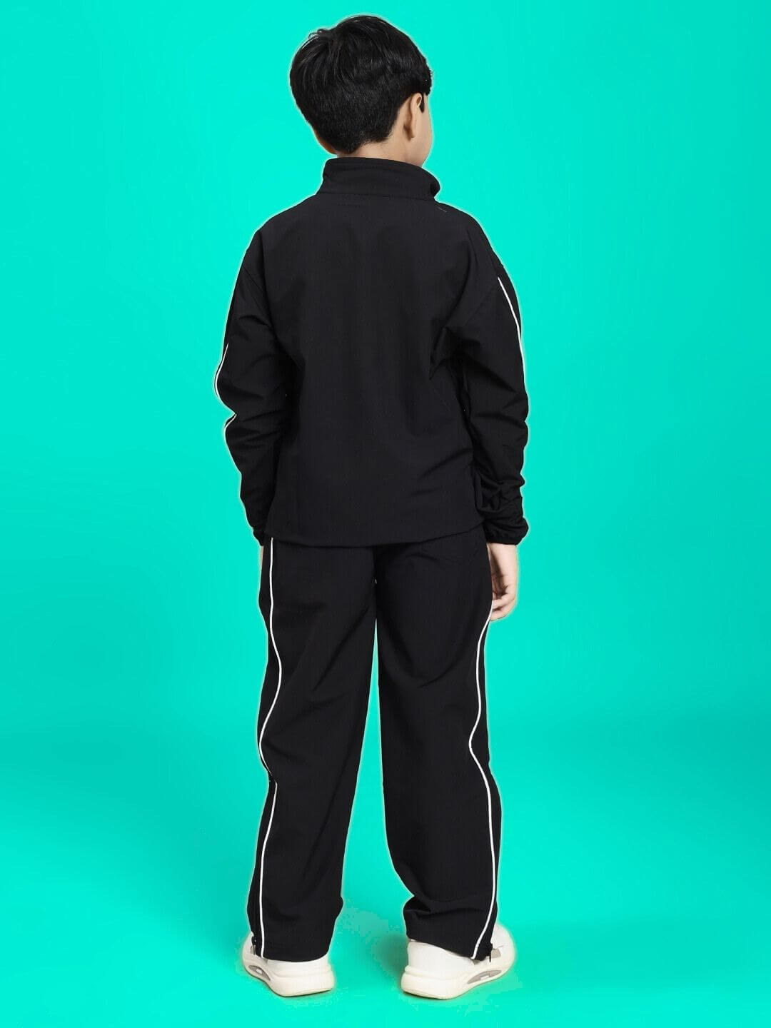 Child wearing RELIGHT RELAXED FIT CO-ORD SET FOR BOYS AND GIRLS BLACK, viewed from back, set against a turquoise background.