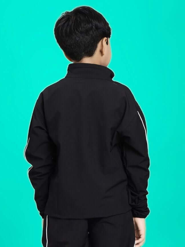 Child wearing RELIGHT RELAXED FIT JACKET FOR BOYS AND GIRLS BLACK, displaying back design against teal background.