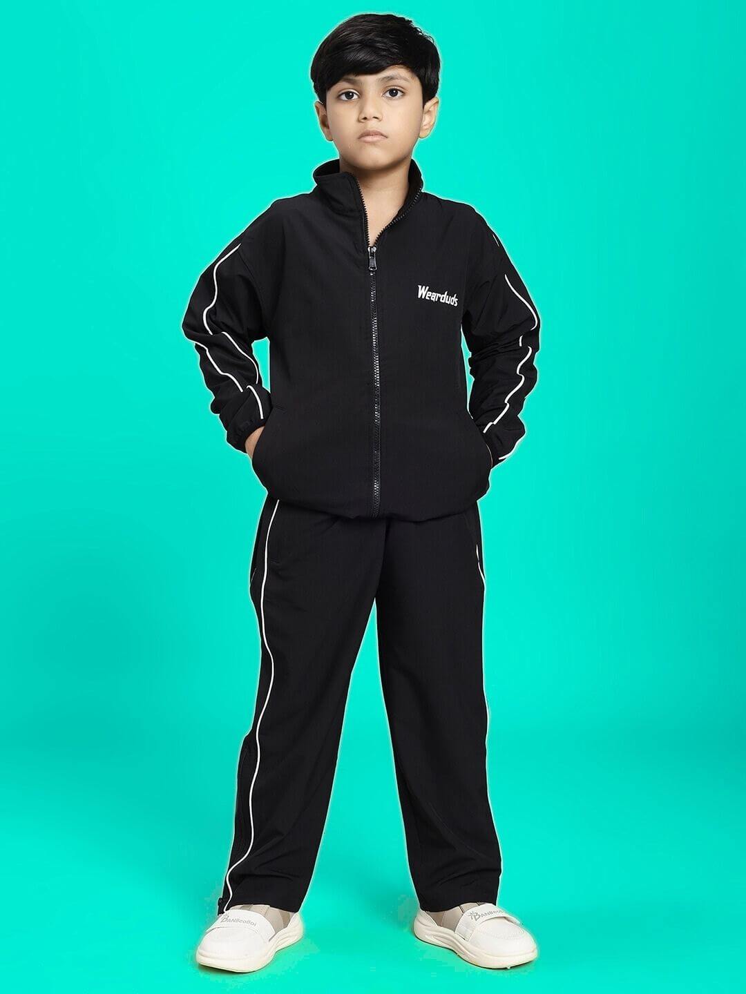 Child wearing RELIGHT RELAXED FIT CO-ORD SET FOR BOYS AND GIRLS BLACK against a teal background.