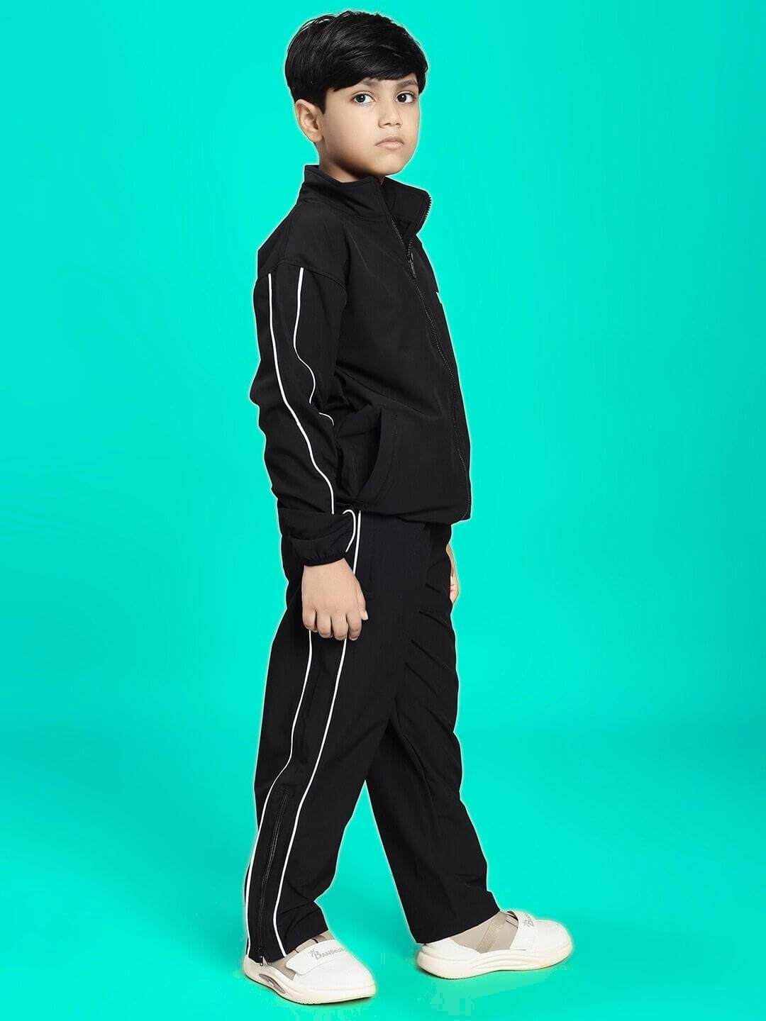 Child wearing RELIGHT RELAXED FIT CO-ORD SET FOR BOYS AND GIRLS BLACK against teal background.