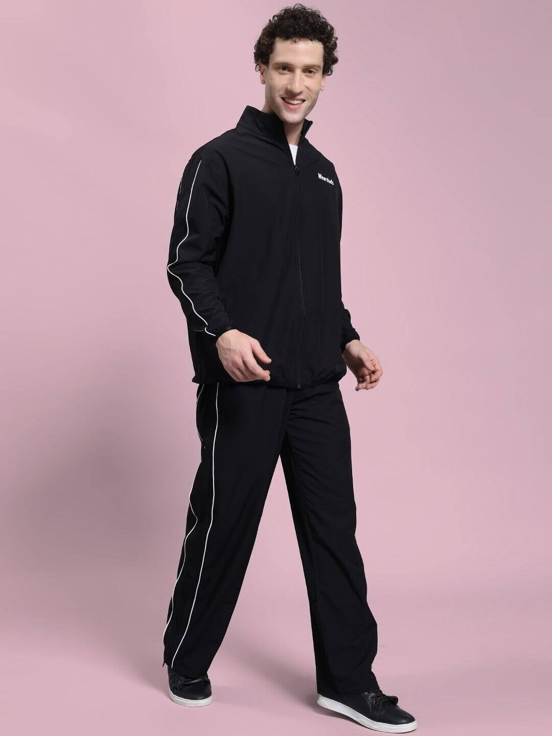 Man wearing RELIGHT RELAXED FIT CO-ORD SET BLACK with thermal-regulating fabric, designed for comfort and style, featuring an oversized hoodie.