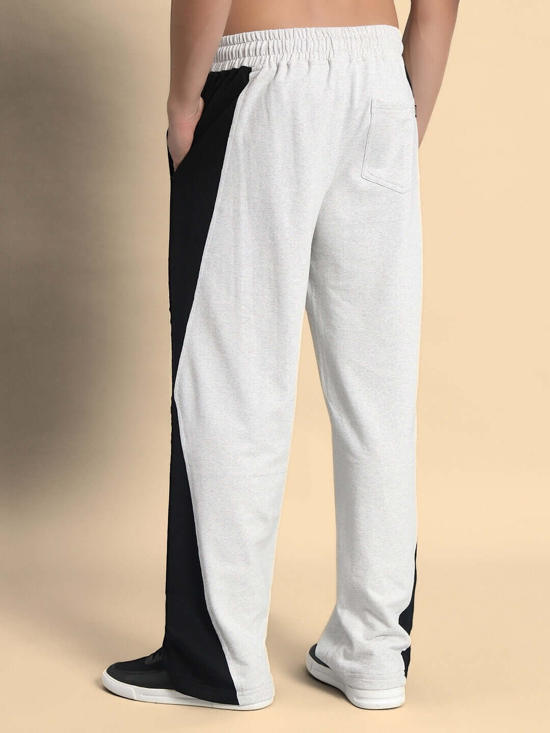 REVIVE side contrast joggers in melange grey and black worn by model, showcasing custom fit and comfortable design for DUDS brand.