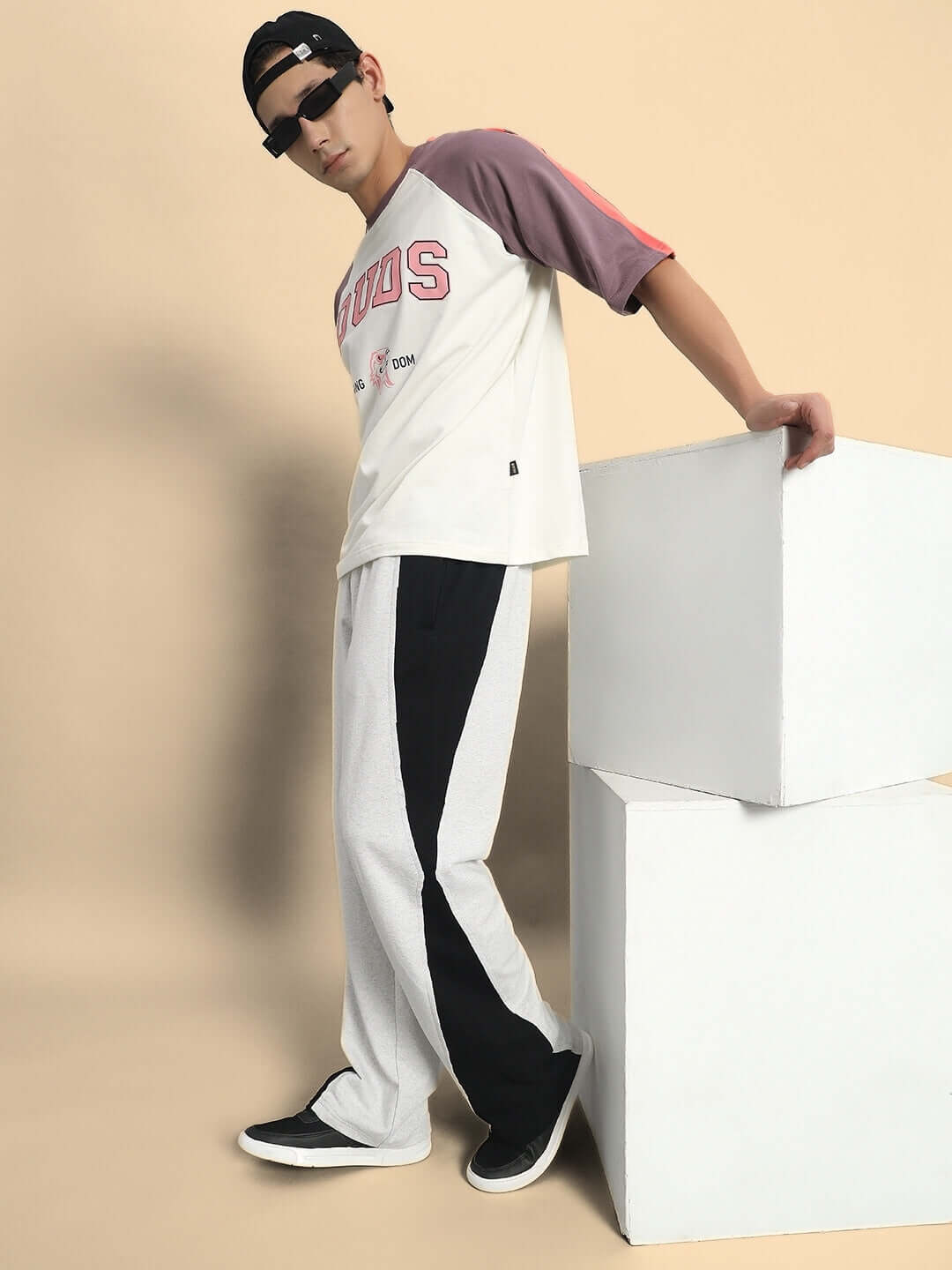 Model wearing REVIVE SIDE CONTRAST JOGGERS in melange grey-black, showcasing the trendy design with a relaxed fit.