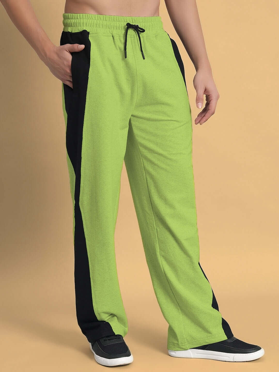 Model wearing neon green joggers with side contrast, designed by DUDS; customizable size available, made to order with a 7-10 day dispatch.
