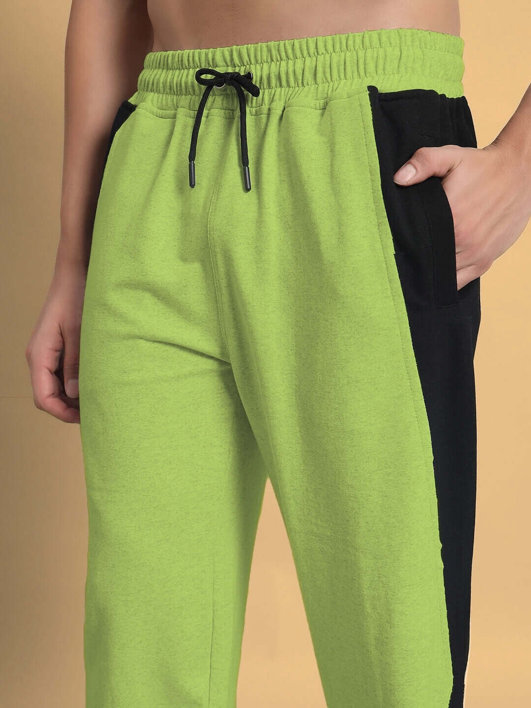 Neon green joggers with side contrast design, featuring an adjustable drawstring for custom fit. Made to order by DUDS tailors.