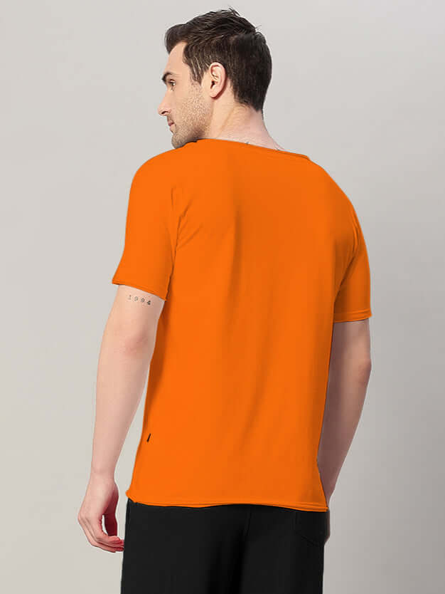 Rear view of model wearing RICKY REGULAR FIT T-SHIRT ORANGE, showcasing the classic cut and vibrant hue.
