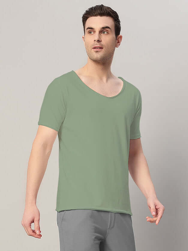 Man wearing RICKY REGULAR FIT T-SHIRT SAGE GREEN, showcasing casual style and sophistication with a modern touch.