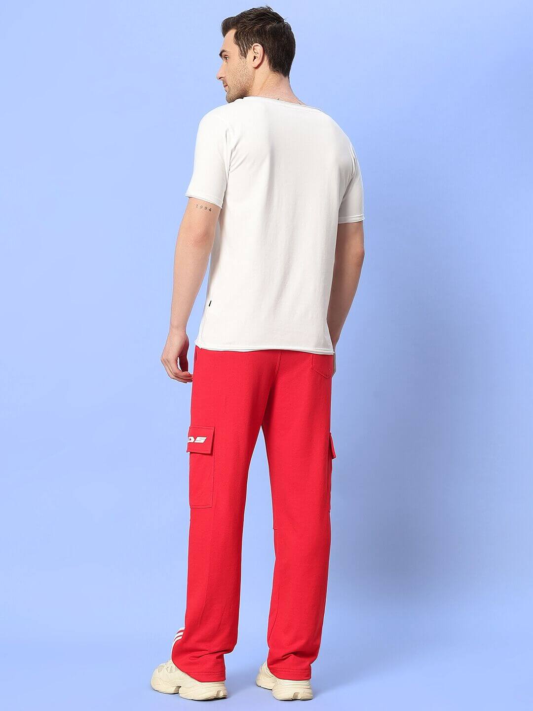 Unisex relaxed fit co-ord set in white t-shirt and red joggers with contrast panel, elastic waistband, styled on model.