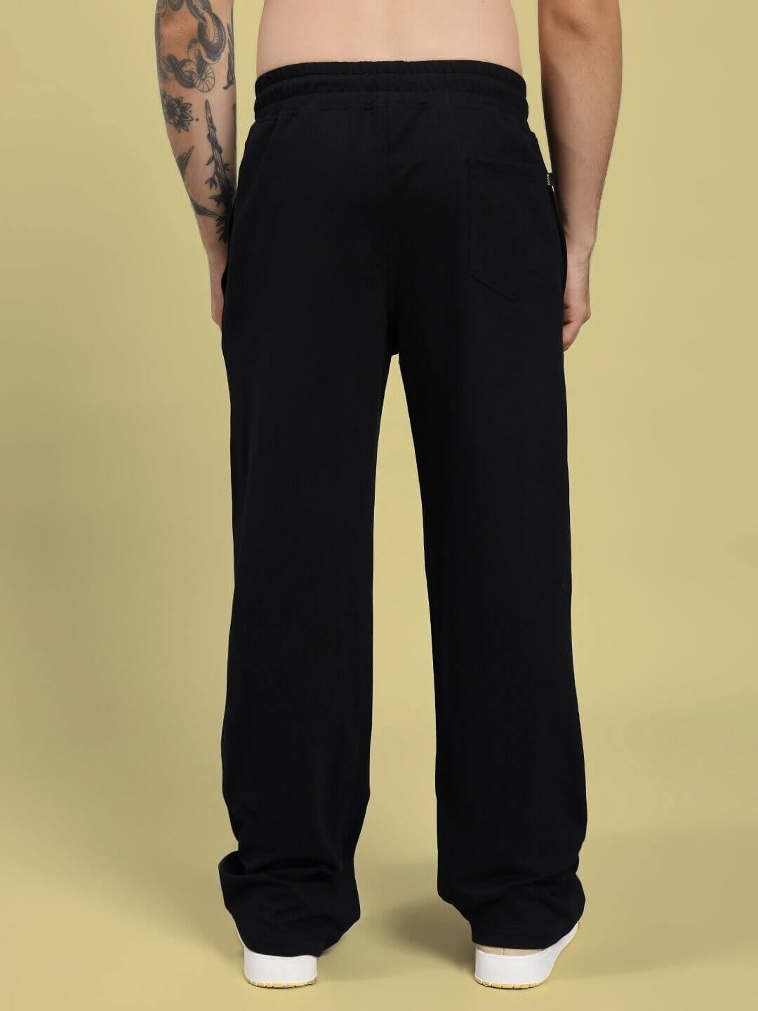 Back view of RIFT RELAXED FIT JOGGER IN BLACK on model, showing relaxed fit and durable fabric suitable for active lifestyles.