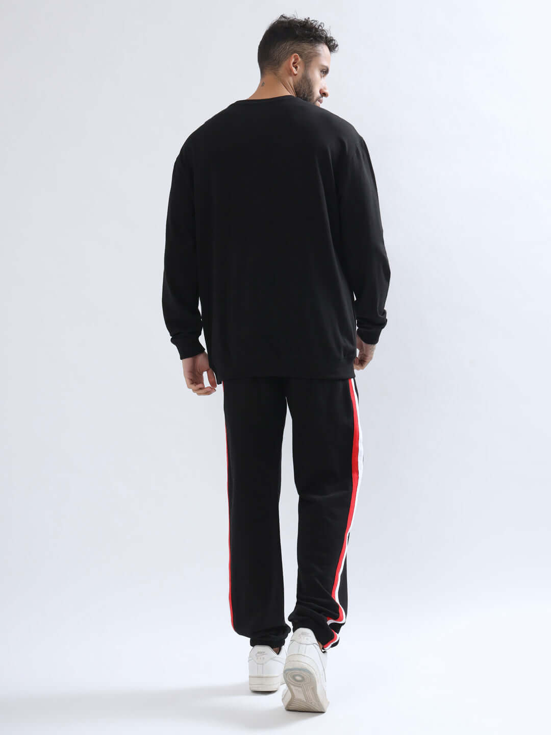 Model wearing RIGHTMAN oversized co-ord set with joggers featuring red and white contrast panel, showcasing back view in premium fabric.