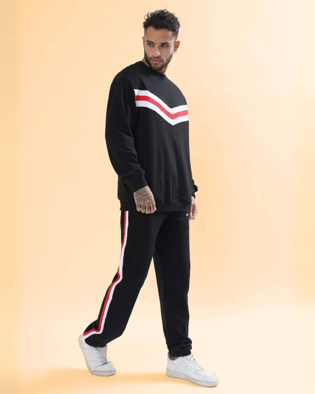 Unisex oversized co-ord set with relaxed fit joggers, red & white contrast panel, elasticated waistband, showcased on male model.