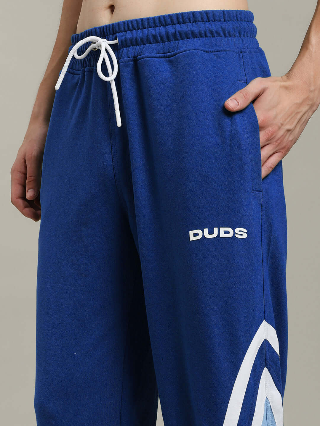 Person wearing blue DUDS RIO ONE Relaxed Fit Joggers with custom fit option.
