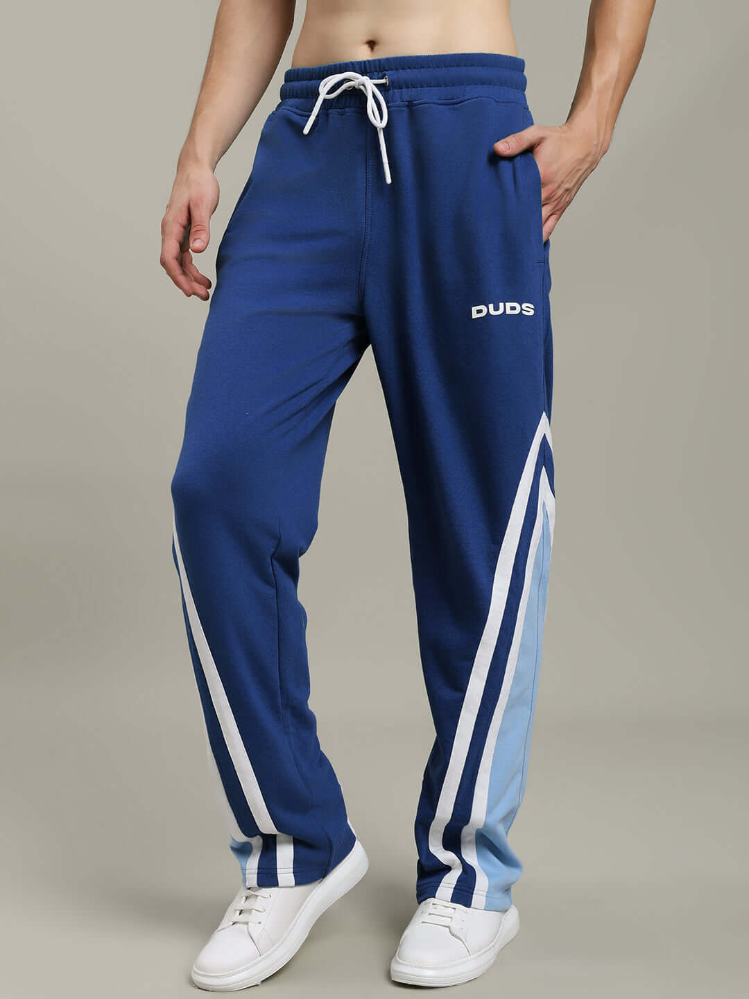 Model wearing Rio One Relaxed Fit Blue Joggers by DUDS, featuring drawstring waist and stripe detail, perfect for casual wear.