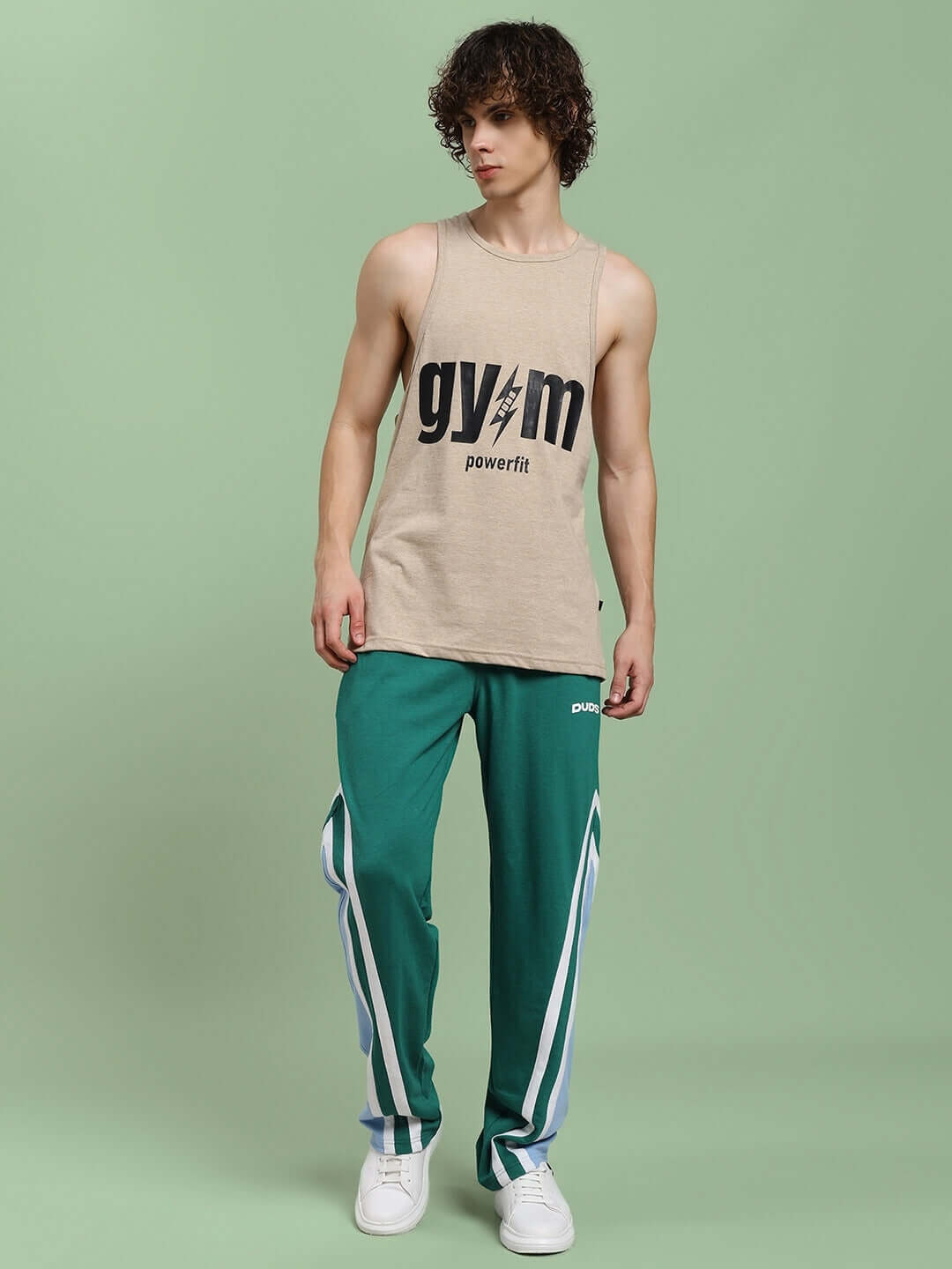 Model wearing RIO ONE RELAXED FIT JOGGERS TEAL GREEN, showcasing casual athleisure style with white sneakers.