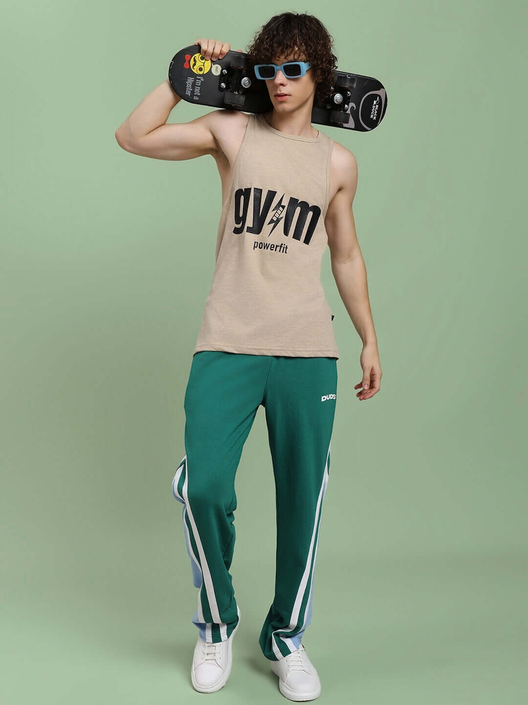 Man wearing RIO ONE RELAXED FIT JOGGERS TEAL GREEN with skateboard, showcasing streetwear style