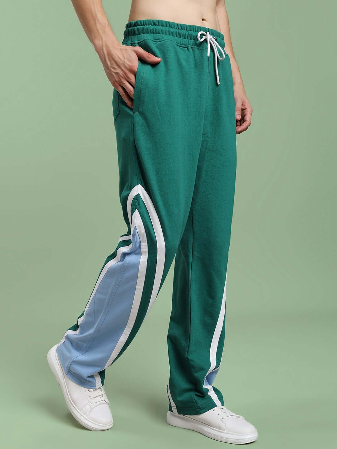 Male model wearing RIO ONE RELAXED FIT JOGGERS TEAL GREEN with stripe detail, showcasing style and comfort in athleisure fashion.