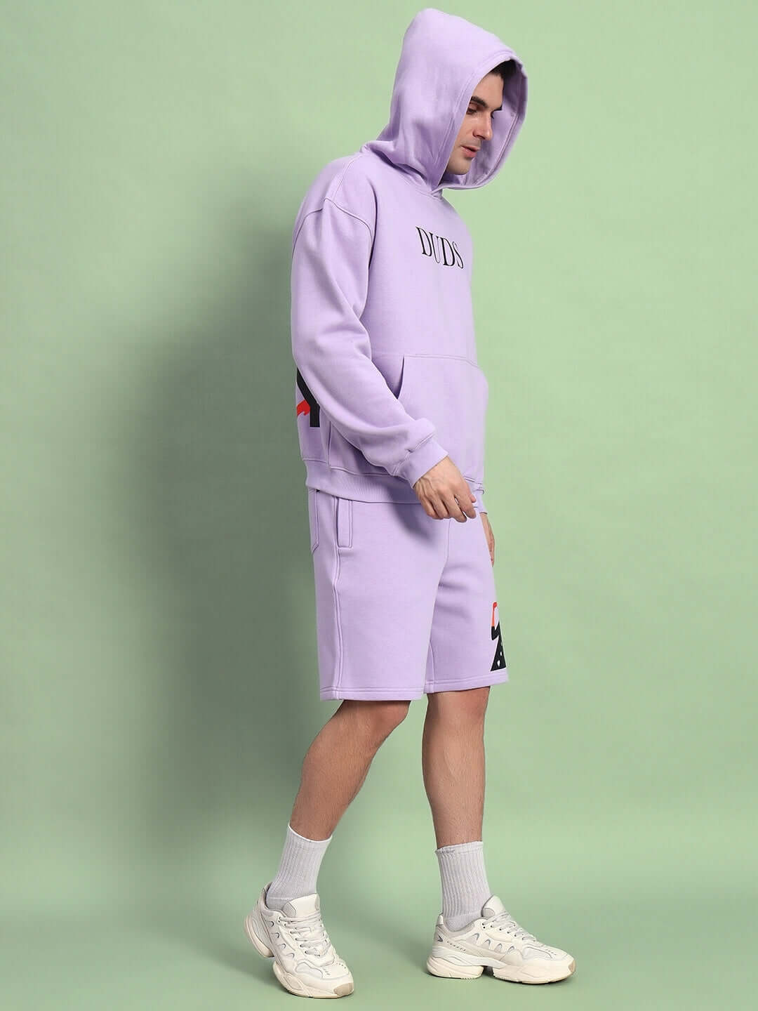 Model wearing WEARDUDS RITZY FLEECE CO-ORD LILAC, showcasing lilac hoodie and shorts set.