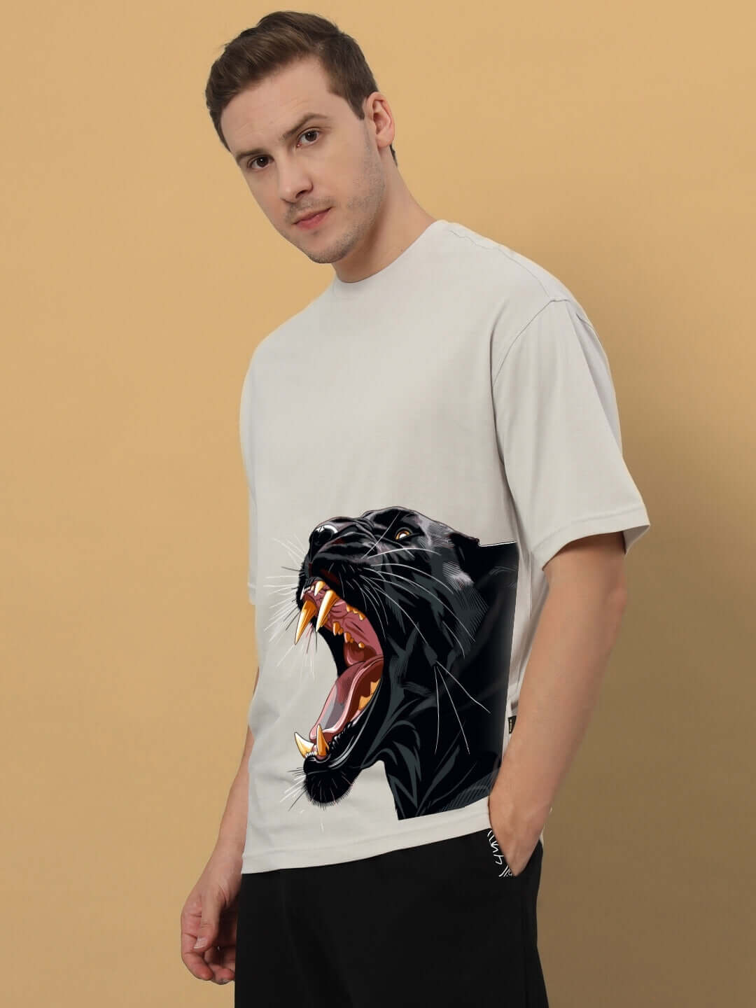 Man wearing ROAR AGAIN PRINTED OVERSIZED T-SHIRT GREY with a bold panther graphic.